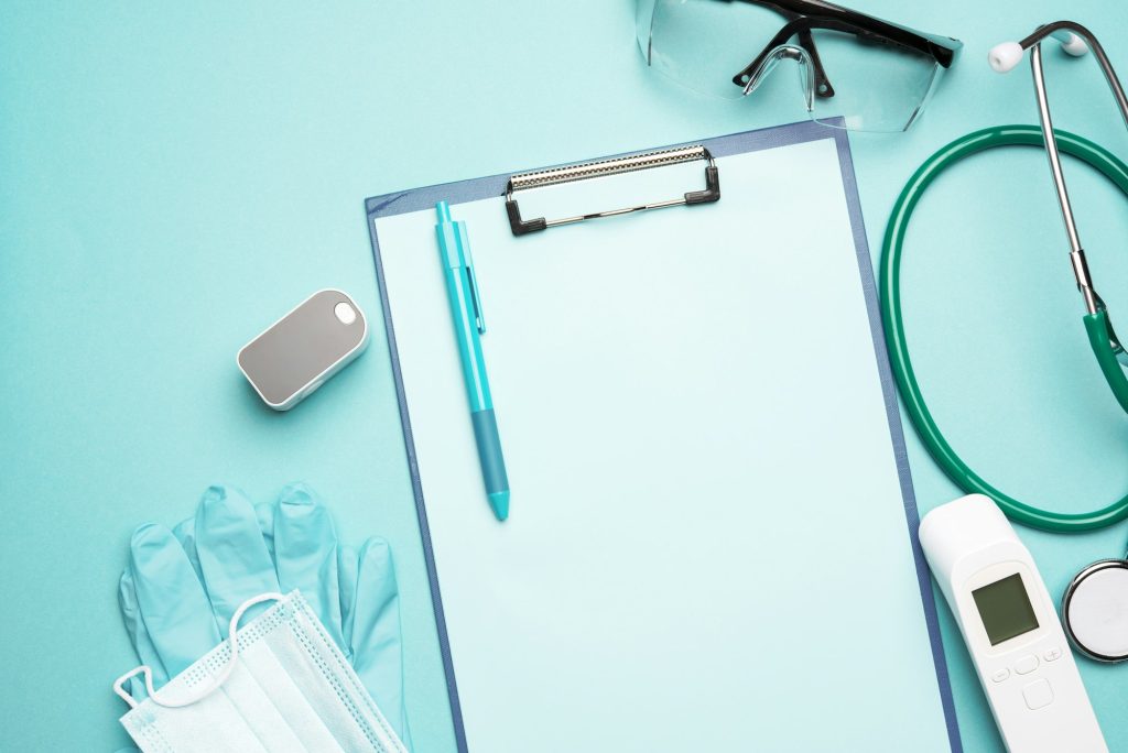 Medical supplies pulse oximeter and electronic thermometer and other medical supplies on a blue back